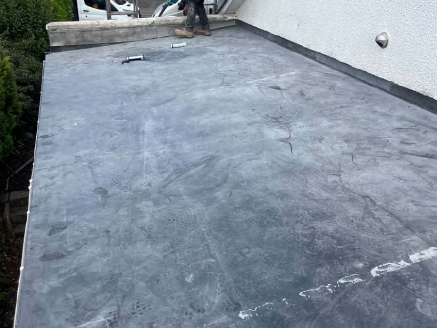 A newly laid flat roof membrane being finished.