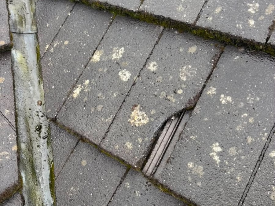 Weathered and damaged tiles in need of repair.
