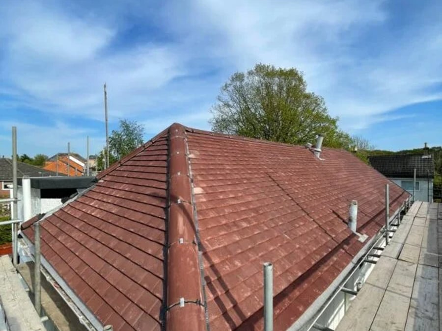 Hipped roof finished with fresh tiles and ridge.