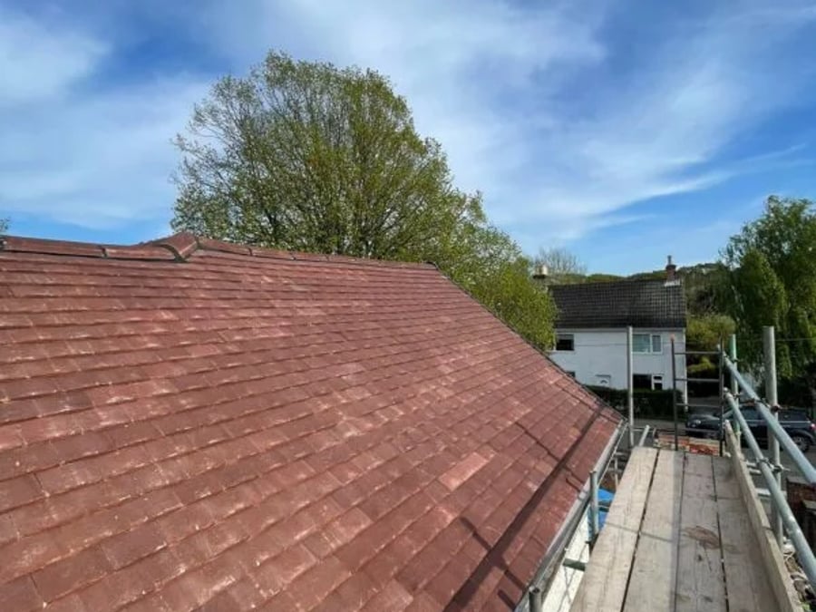 Pitched roof re-tiled with scaffolding in place.