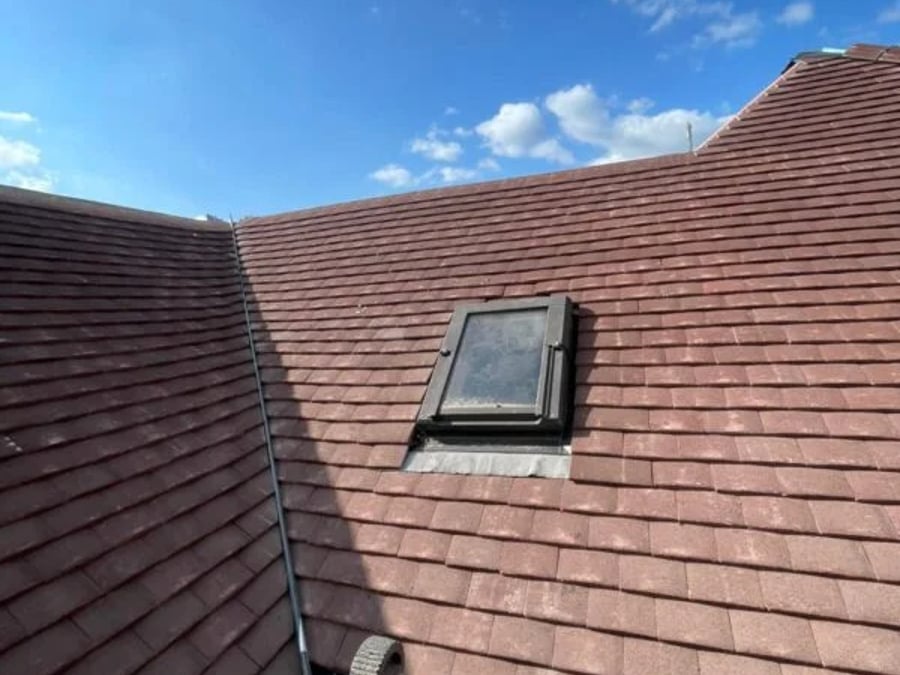 Tiled roof with a neatly fitted roof window.