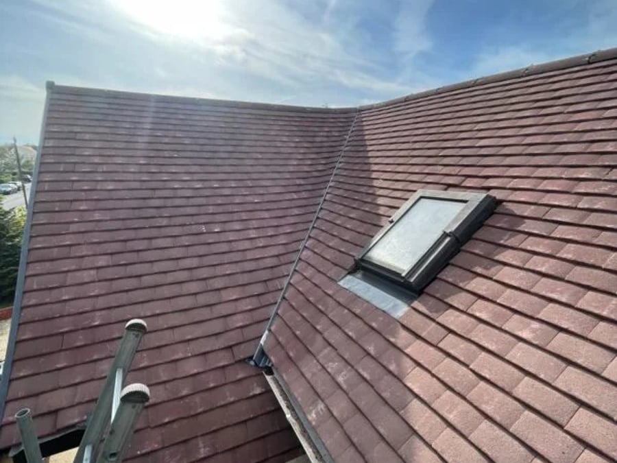 Newly tiled roof with roof window fitted.