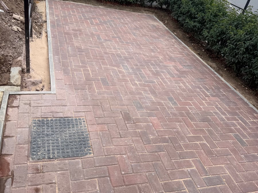 Block paved driveway in herringbone pattern.